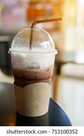 Chocolate Frappe on a Table in a Coffee Shop with Sun Rays, selective focus