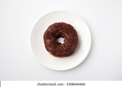 chocolate frosted doughnut on plate isolated on white background - Powered by Shutterstock