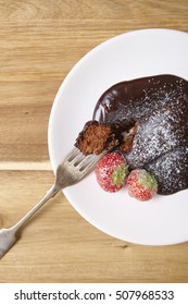 A Chocolate Fudge Brownie Dessert On A  Wooden Kitchen Counter Background