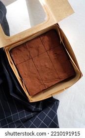 Chocolate Fudge Brownie In A Paper Box.