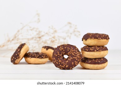Chocolate glazed donuts with nut sprinkles 