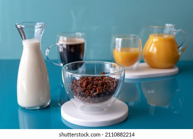Chocolate granola with vegetable milk, coffee in a cup, orange juice for breakfast. Proper nutrition concept. Sugarless.