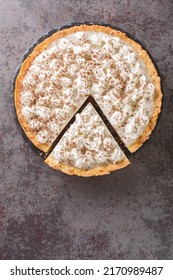 Chocolate Haupia Pie Is A Creamy Coconut Custard Pie In A Flaky Pie Crust And Topped With Whipped Cream Closeup In The Plate On The Table. Vertical Top View From Above
