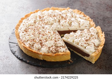 Chocolate Haupia Pie Is A Creamy Coconut Custard Pie In A Flaky Pie Crust And Topped With Whipped Cream Closeup In The Plate On The Table. Horizontal
