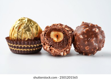 chocolate and hazelnut confectionery balls. chocolate sweet made. Chocolate candies in a gold wrapper - Powered by Shutterstock