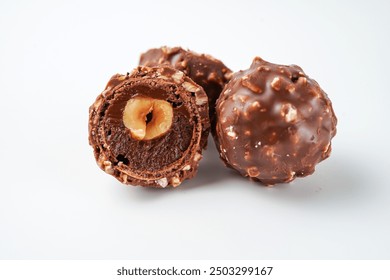 chocolate and hazelnut confectionery balls. chocolate sweet made. Chocolate candies in a gold wrapper - Powered by Shutterstock