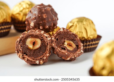 chocolate and hazelnut confectionery balls. chocolate sweet made. Chocolate candies in a gold wrapper - Powered by Shutterstock