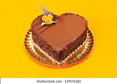 Chocolate Heart Cake On Orange Background.  Copy Space On Cake