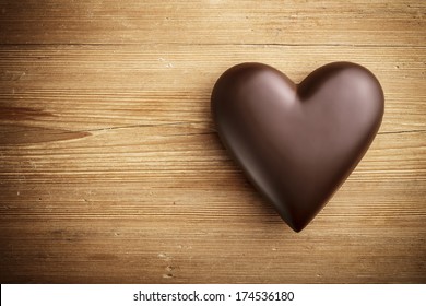 Chocolate heart on wooden background  - Shutterstock ID 174536180