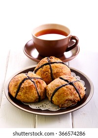 Chocolate Hot Cross Buns On Plate And Cup Of Tea