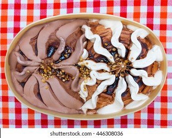 Chocolate Ice Cream In Box On A Table With Checkered Cloth. Top View