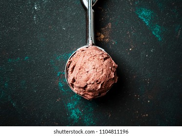 Chocolate Ice Cream In Metal Spoon For Ice Cream, Dark Background, Top View