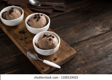 Chocolate Ice Cream On Wooden Background, Copy Space. Homemade Vegan Keto Chocolate Ice Cream With Chocolate Chips - Healthy Summer Dessert.