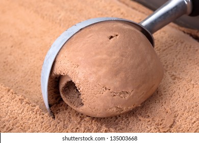 Chocolate Ice Cream Scooped Out Of Container.