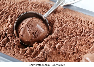 Chocolate Ice Cream Scooped Out From Container