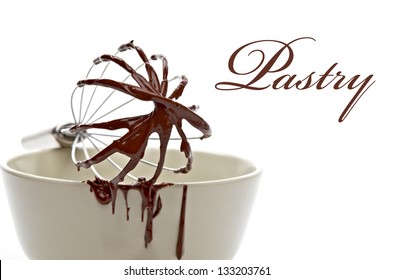 Chocolate Immersed Whisk On The Bowl Isolated On White Background