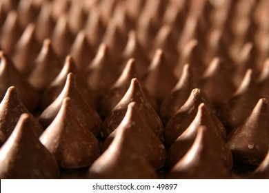 chocolate kisses all lined up on a silver tray