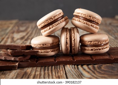 Chocolate Macarons On A Wooden Table