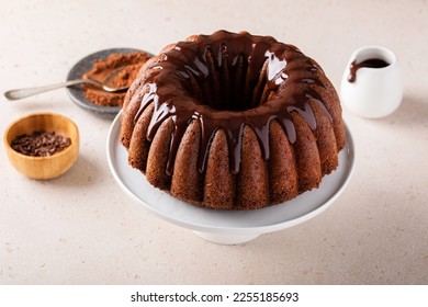 Chocolate marble bundt cake or zebra cake with chocolate glaze drizzled on top freshly baked