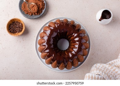 Chocolate marble bundt cake or zebra cake with chocolate glaze drizzled on top freshly baked overhead view with copy space