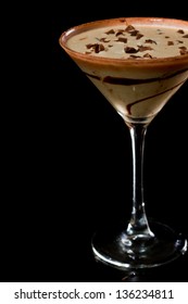 Chocolate Martini Isolated On A Black Background With Chocolate Swirl And Cocoa Powder On The Rim