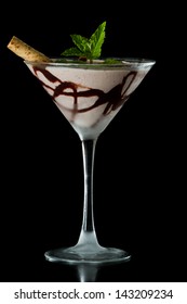 Chocolate Martini Served Isolated On A Black Background With Chocolate Swirl And A Wafer Stick