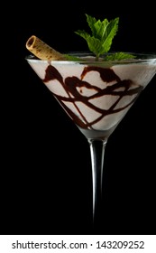 Chocolate Martini Served Isolated On A Black Background With Chocolate Swirl And A Wafer Stick