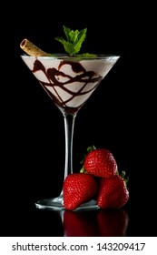 Chocolate Martini Served Isolated On A Black Background With Chocolate Swirl And A Wafer Stick