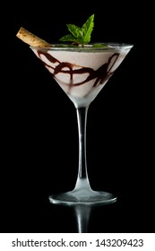 Chocolate Martini Served Isolated On A Black Background With Chocolate Swirl And A Wafer Stick