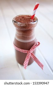 Chocolate Milk In A Bottle With Red Ribbon And Red Straw