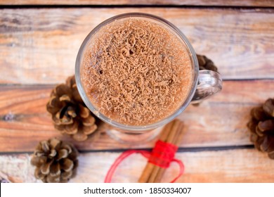 Chocolate Milk, Cinnamon Sticks And Cones On A Wooden Table