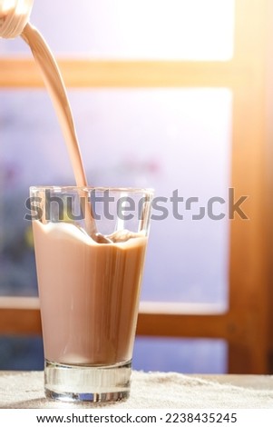 Chocolate milk fills a glass