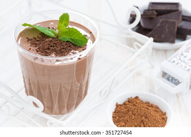 chocolate milkshake and ingredients, close-up, horizontal