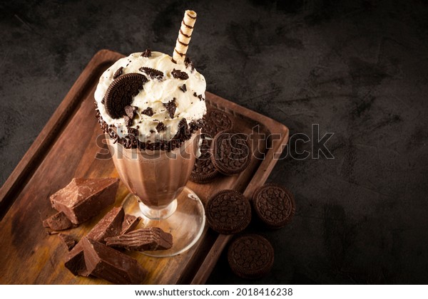 Chocolate milkshake with pieces of chocolate\
chip cookies.