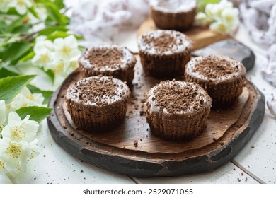 Chocolate mini cheesecakes on a wooden board. Cheesecakes for breakfast. - Powered by Shutterstock