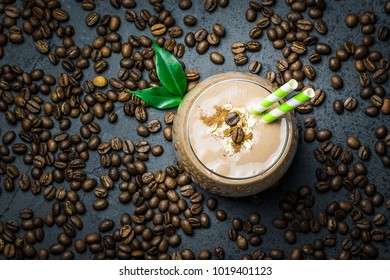 Chocolate Mocha Breakfast Smoothie And Coffee Beans On Dark Concrete Background. Top View, Space For Text, Close Up.