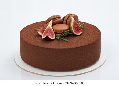 Chocolate Mousse Cake Decorated With Pieces Of Figs, Macaroons  And Rosemary On White Background