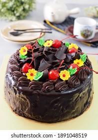 Chocolate Mousse Cake With Chocolate Ganache On Top And Flowers Chocolate Mousse Decoration With Cherry And Gratter Chocolated As Topping