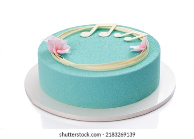 Chocolate Mousse Cake On A White Background, Decorated With Flowers And Notes Of White Chocolate. Close-up View. Turquoise Mousse Cake.