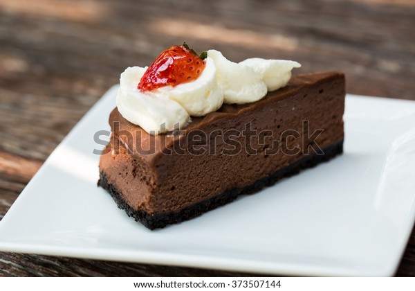 Chocolate mousse\
cake with whipping cream\
topping.