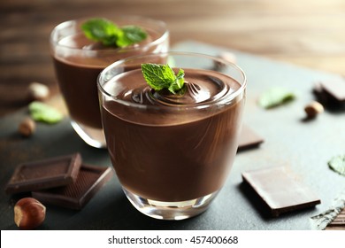 Chocolate Mousse With Mint In Portion Glasses On Slate Cheese Board