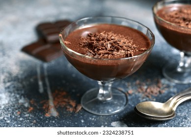 Chocolate mousse with nuts in a glasses on a slate, stone or concrete table. - Powered by Shutterstock