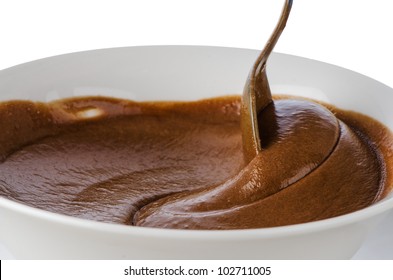 Chocolate Mousse On A White Mug With Spoon On White Background.