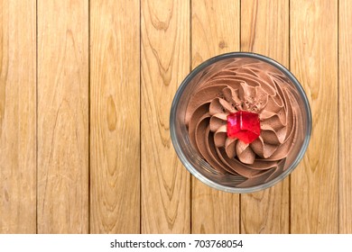 Chocolate Mousse Top View In Glass On  Wooden Background.