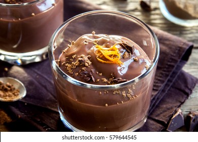 Chocolate Mousse Topped With Orange Zest In Glasses Over Wooden Background Close Up - Delicious Homemade Chocolate Pudding