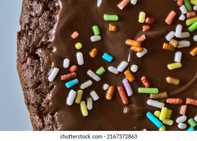 Chocolate muffin with colored sugar crumbles in closeup