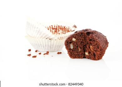  Chocolate Muffin Cross Section Isolated On White. Paper And Crumbs In Background.