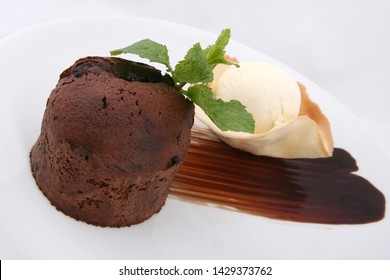 
chocolate muffin and ice cream ball. beautifully served on a white plate. on a white background