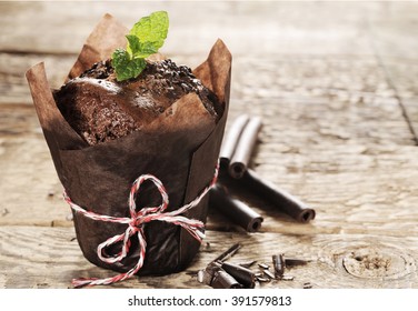 chocolate muffin with mint on a wooden table - Powered by Shutterstock