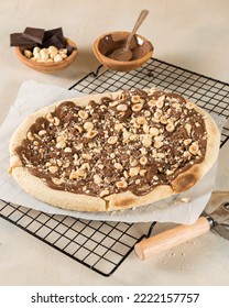 Chocolate nutella pizza with nuts dessert